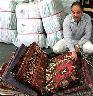 Elie inspects a new shipment of oriental rugs